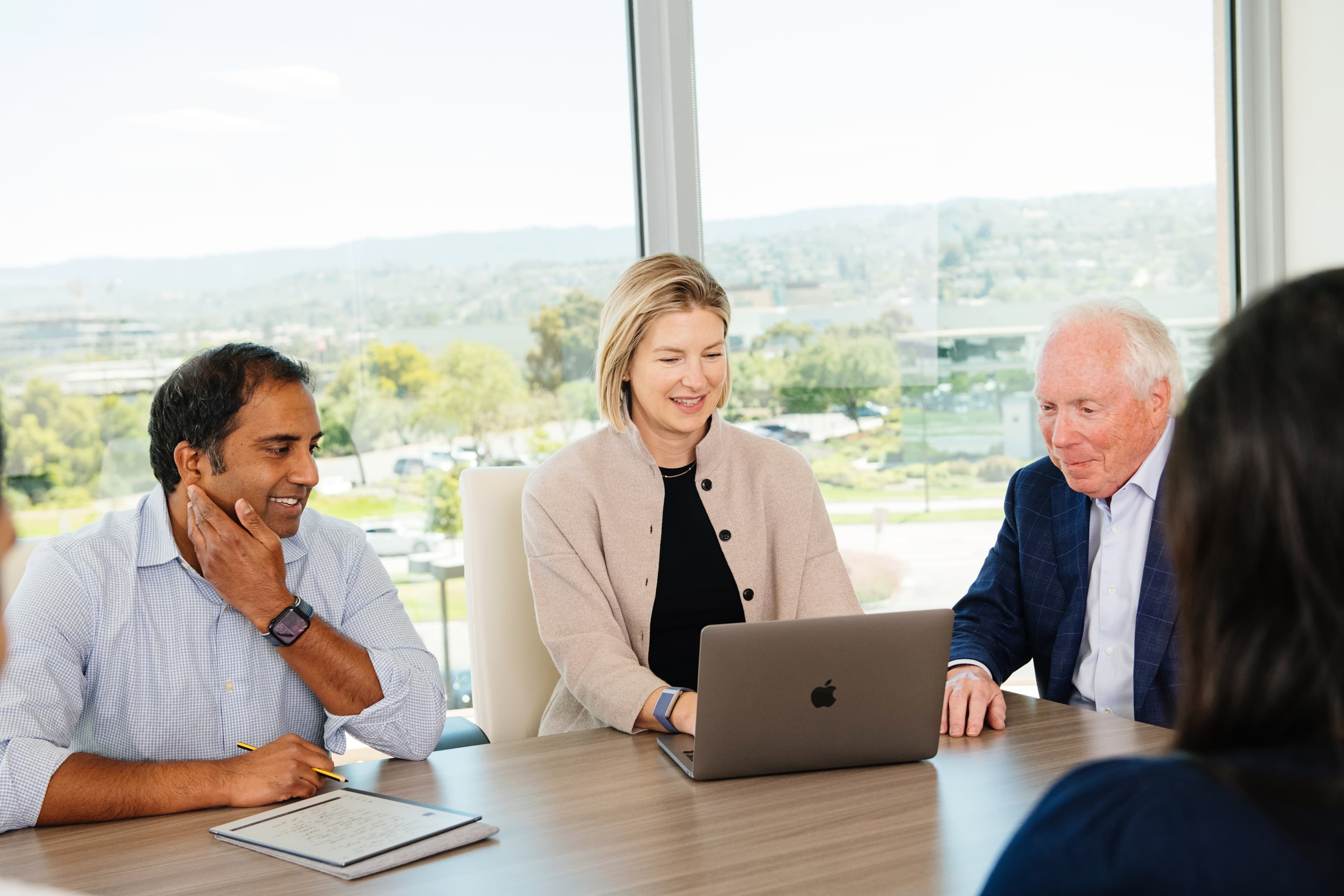 three people sat at a desk 